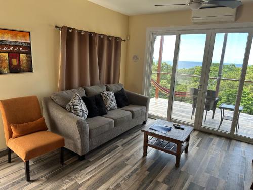 a living room with a couch and a chair at Tree Top Suites & Resort in Cohoon Ridge