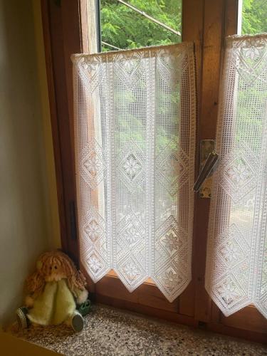 a teddy bear sitting in front of a door at Dai nonni di Preteto in Veccialone