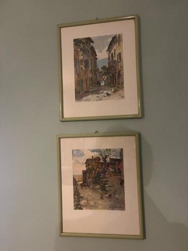 two framed paintings hanging on a wall at Dai nonni di Preteto in Veccialone