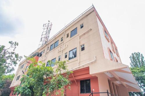 a tall building with a red and white at Happy Stay in Bengaluru
