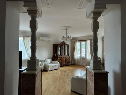 a large living room with a couch and a chandelier at Terrace NANA in Tbilisi City