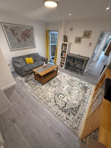 a living room with a couch and a coffee table at Bright and Spacious Entire One Bedroom Apartment with Living Room and Private Garden in London