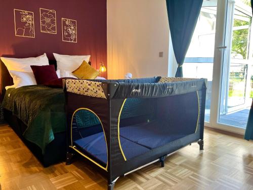 a bedroom with a bed with a blue bed frame at flair Apartment Blossom I BBQ I 2xParken I Terrasse I Kaffee I Waschmaschine I Disney plus in Fulda