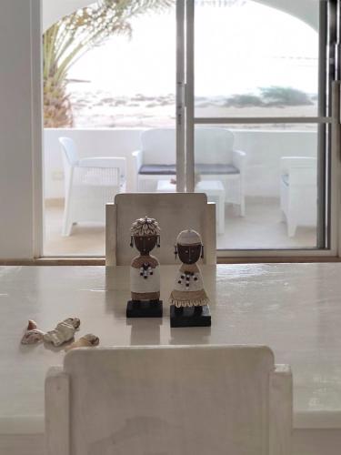 two figurines sitting on a table in a living room at Alma MIRIAM in Sal Rei