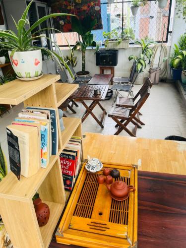 a table with a shelf with books and fruit on it at Hello SaiGon Homestay in Ho Chi Minh City