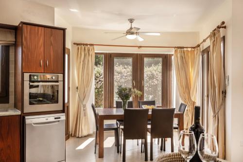 a kitchen and dining room with a table and chairs at Villa Tsikkos Dio in Limassol