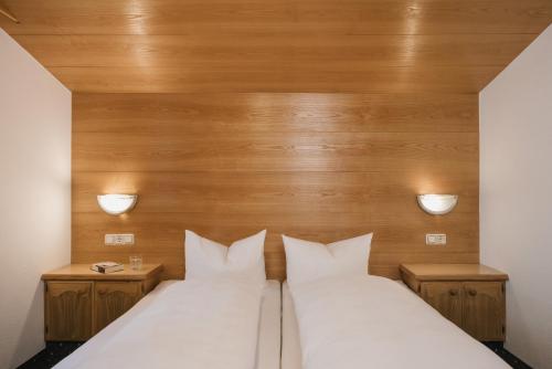 a bed with two white pillows in a room at Haus Rosemarie in Serfaus