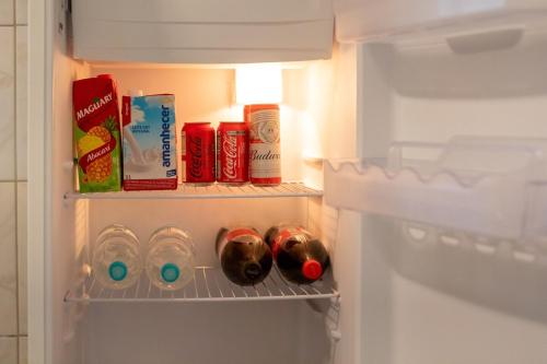 an open refrigerator with some food and drinks at Casa Centro de Guabiruba in Guabiruba