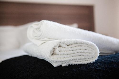 a pair of towels sitting on top of a bed at Oasis Comfort Apartment in Midrand