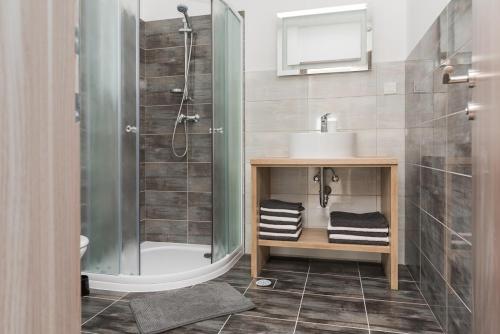 a bathroom with a shower and a sink at M.G Apartments in Brodarica
