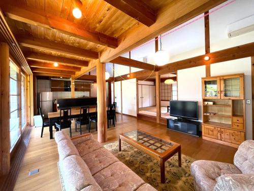 a living room with a couch and a piano at UMIIE-小松浜-Private STAY in Miyazu