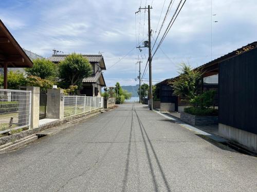 an empty street in a house with a fence at UMIIE-小松浜-Private STAY in Miyazu