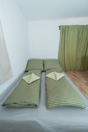 a bed with two pillows on top of it at Harmónia Ház in Orfű
