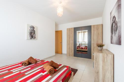 a bedroom with a large bed in a room at Modern 3BR w Terrace Near Beaches & Restaurants by QuickTrips in St. Paul's Bay