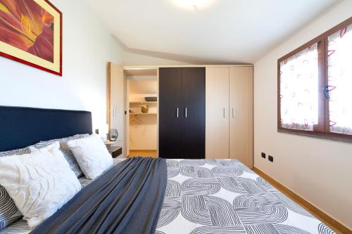 a bedroom with a large bed and a window at SARDINIA RE - Attico Monte Oro in Sassari
