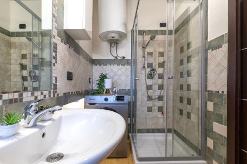 a bathroom with a sink and a shower at SARDINIA RE - Attico Monte Oro in Sassari