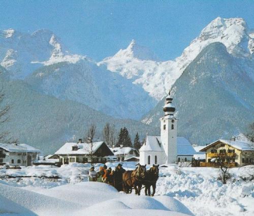a group of people on horses in the snow with a lighthouse at FeWo Schlosspark Grubhof in Sankt Martin bei Lofer