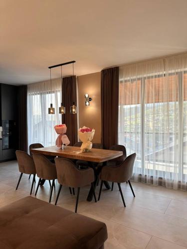 a dining room with a wooden table and chairs at Chalet 348 in Palyanytsya
