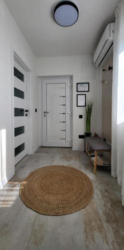 a large room with a large rug and a door at Apartman Renata in Županja