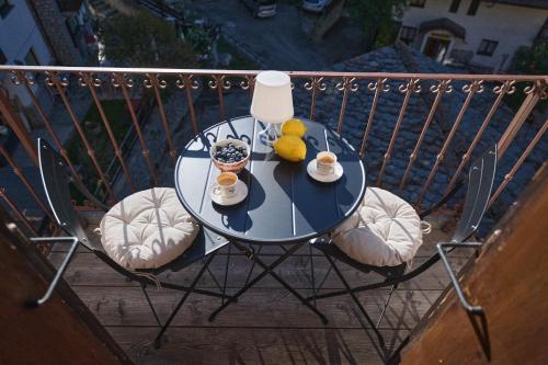 a table with two cups and two teddy bears on a balcony at Luxury apartment in Valtournenche in Valtournenche