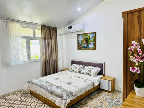 a bedroom with a bed and a window at Mansard 91 in Sergeli Bekati