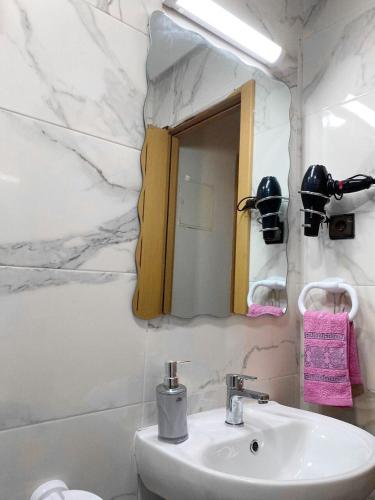 a bathroom with a sink and a mirror at Entire condo hosted by Dar Al Khayma in Agadir