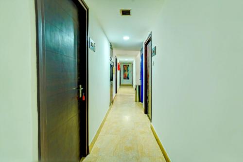 a hallway with a row of doors in a building at Hotel O Sunshin Deluxe in Nagpur