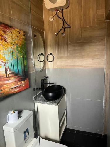 a bathroom with a toilet and a sink at Furnished two bedrooms at Wuye Abuja in Ankuru