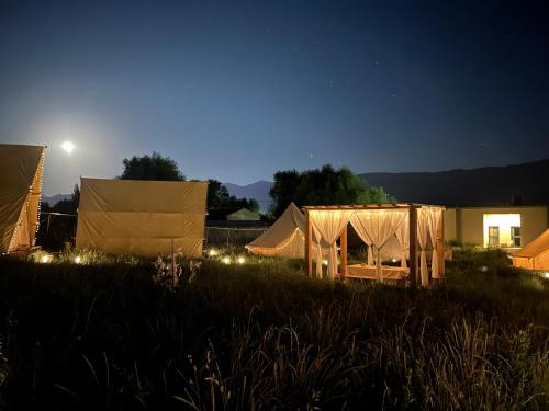 a group of tents in a field at night at Nalati Jianxian B&B in Narat