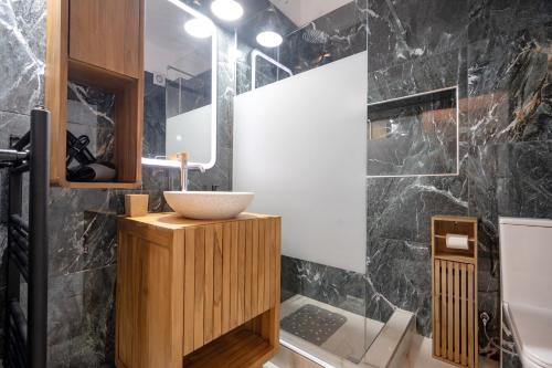 a bathroom with a sink and a mirror at Barbara's sweet home Glyfada by ΜΡS in Athens