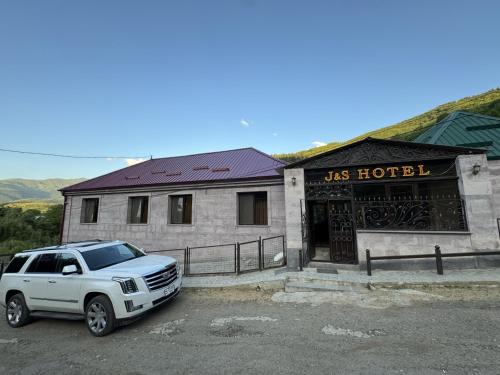 a white truck parked in front of a building at j&s family hotel in Vanadzor