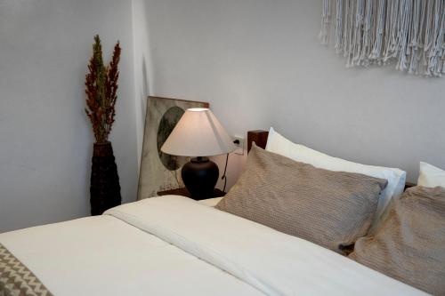 a bedroom with a white bed and a lamp at Nalati Jianxian B&B in Narat