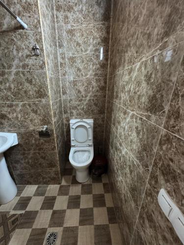a bathroom with a toilet and a shower and a sink at j&s family hotel in Vanadzor