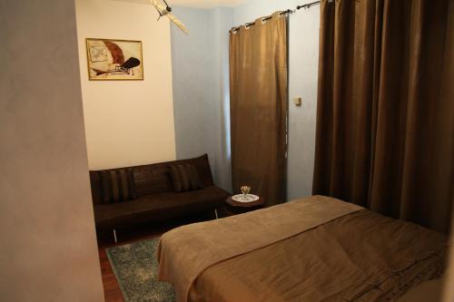 a small room with a bed and a couch at Atmos Luxe Navigli in Milan