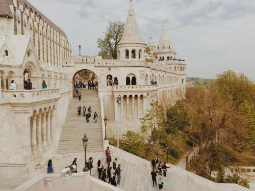 a group of people walking up the stairs of a building at Hotel Metro in Budapest