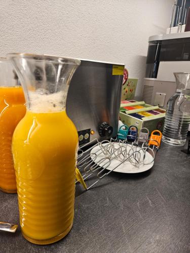 a glass vase filled with orange juice on a counter at Lisas Schröcken in Schröcken