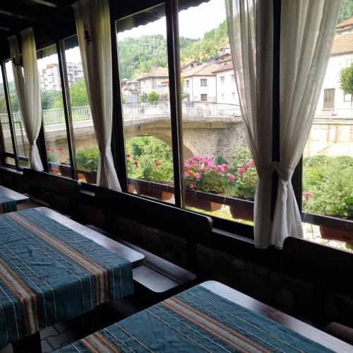 a room with windows and a view of a bridge at Къща за гости Тони in Zlatograd
