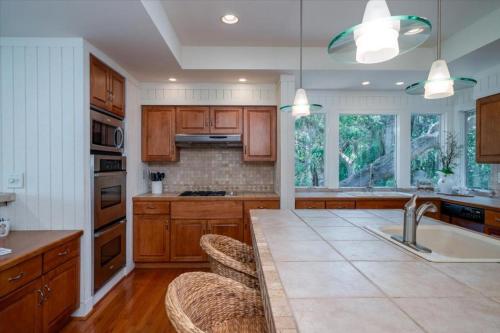 a kitchen with wooden cabinets and a large kitchen island at 2710 Gnarled Pine in Seabrook Island