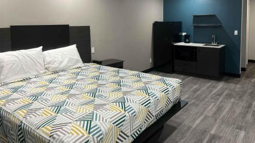 a bedroom with a bed and a sink at Studio 6 Oklahoma City, OK South in Oklahoma City