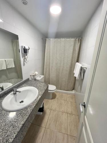 a bathroom with a sink and a toilet at Apartamentos Florida Gran Canaria Adults Only in Puerto Rico de Gran Canaria