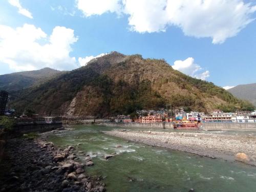 a mountain next to a river with a town at Anand Hill View Apartment in Nākuri