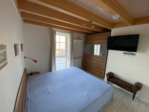 Ένα ή περισσότερα κρεβάτια σε δωμάτιο στο Ferienhaus Kapitänseck - Greetsiel