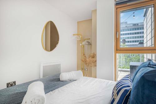 a bedroom with a white bed and a window at Golden View-Wyndale Living-Central Birmingham in Birmingham