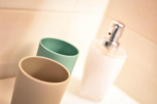 a bottle of soap and a cup on a counter at Lisas Schröcken in Schröcken