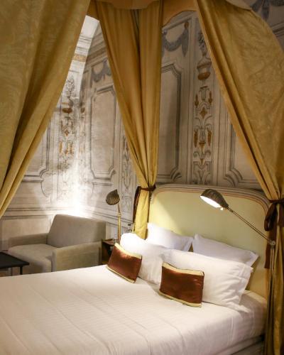 a bed with two pillows on it in a bedroom at Château de Bagnols in Bagnols