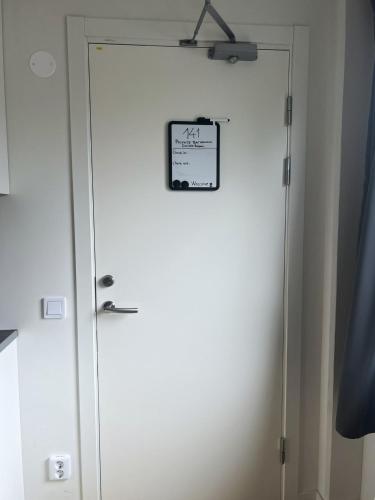 a white door with a sign on it at Rentalux Apartment Rooms in Timrå