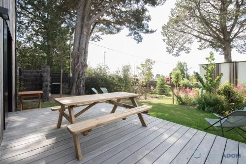 a wooden picnic table on a wooden deck at Sekoya Lodge - Proche plage - golf in Pornic