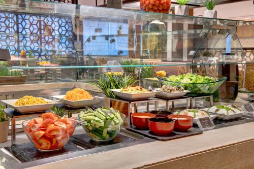 a buffet line with different types of vegetables in bowls at Two Seasons Hotel & Apartments in Dubai