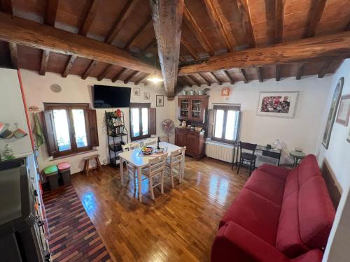 a living room with a red couch and a table at il nido in Colle Val D'Elsa