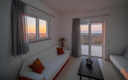 Una sala de estar con un sofá y una ventana grande. en Casa Flora, en Kefalos
